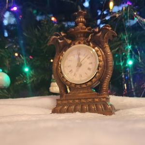 The table clock is Dark brown with gold - For decoration, does not work